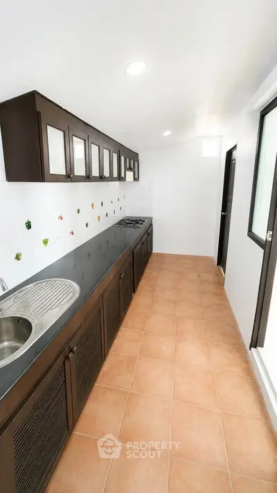 Modern kitchen with sleek cabinetry and gas stove in a spacious layout.