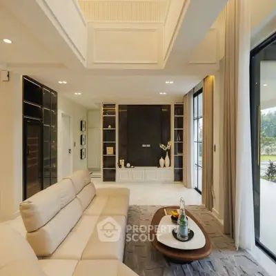 Luxurious modern living room with elegant decor and large windows offering natural light.