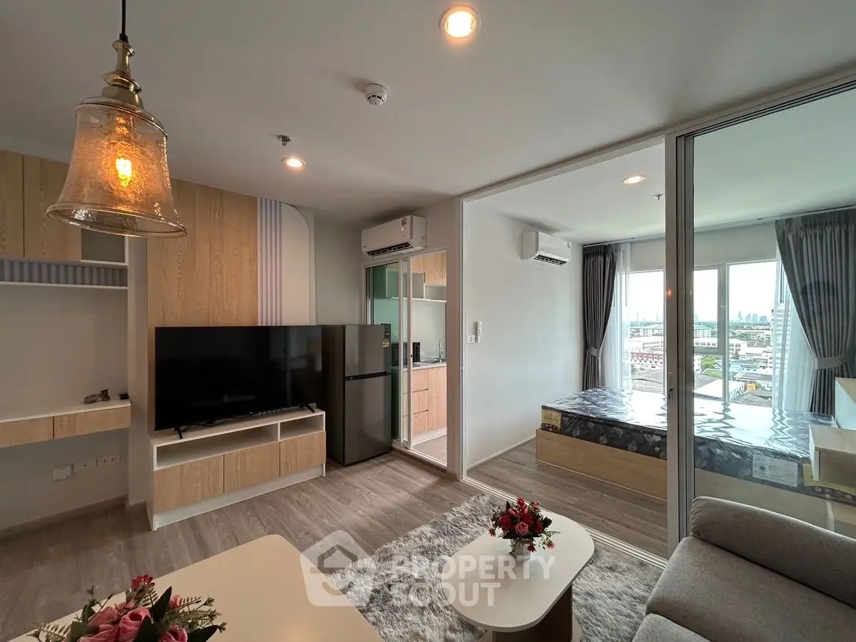 Modern open-plan living room with glass partition and stylish decor