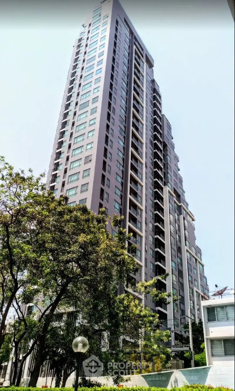 Stunning high-rise apartment building with modern architecture and lush surroundings.