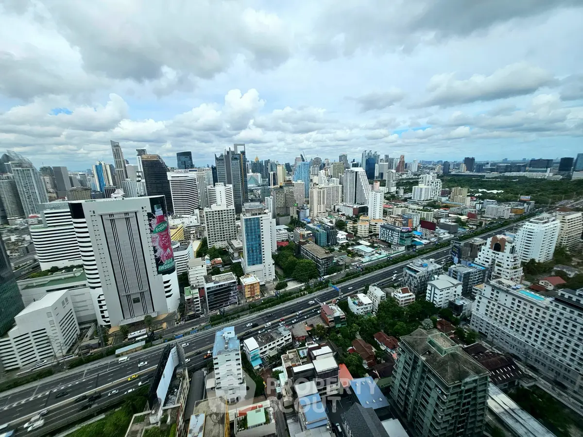 Stunning panoramic cityscape view from a high-rise building, showcasing urban skyline and vibrant city life.