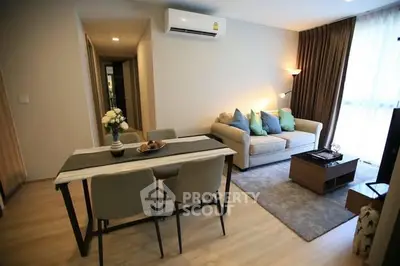 Modern living room with cozy sofa and dining area in stylish apartment.