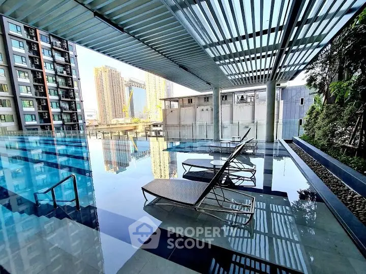 Luxurious modern pool area with city skyline view and stylish lounge chairs.