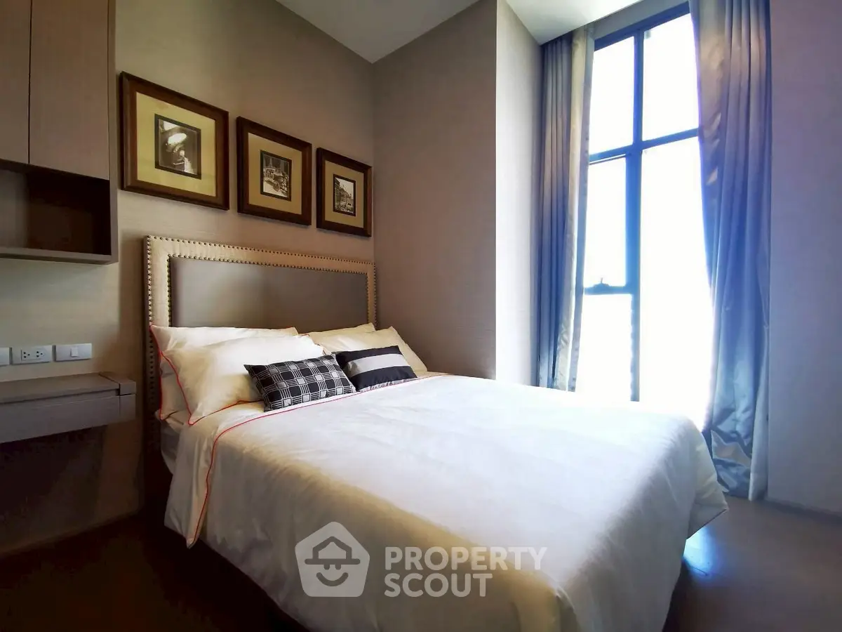 Elegant bedroom with large window and stylish decor in modern apartment