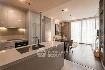 Modern open-plan kitchen and living room with sleek design and natural light