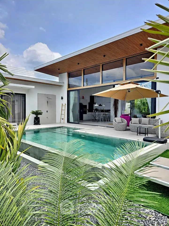 Luxurious modern villa with private pool and stylish outdoor seating area, perfect for relaxation and entertainment.