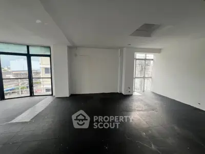 Spacious unfurnished room with large windows and city view, ideal for customization.