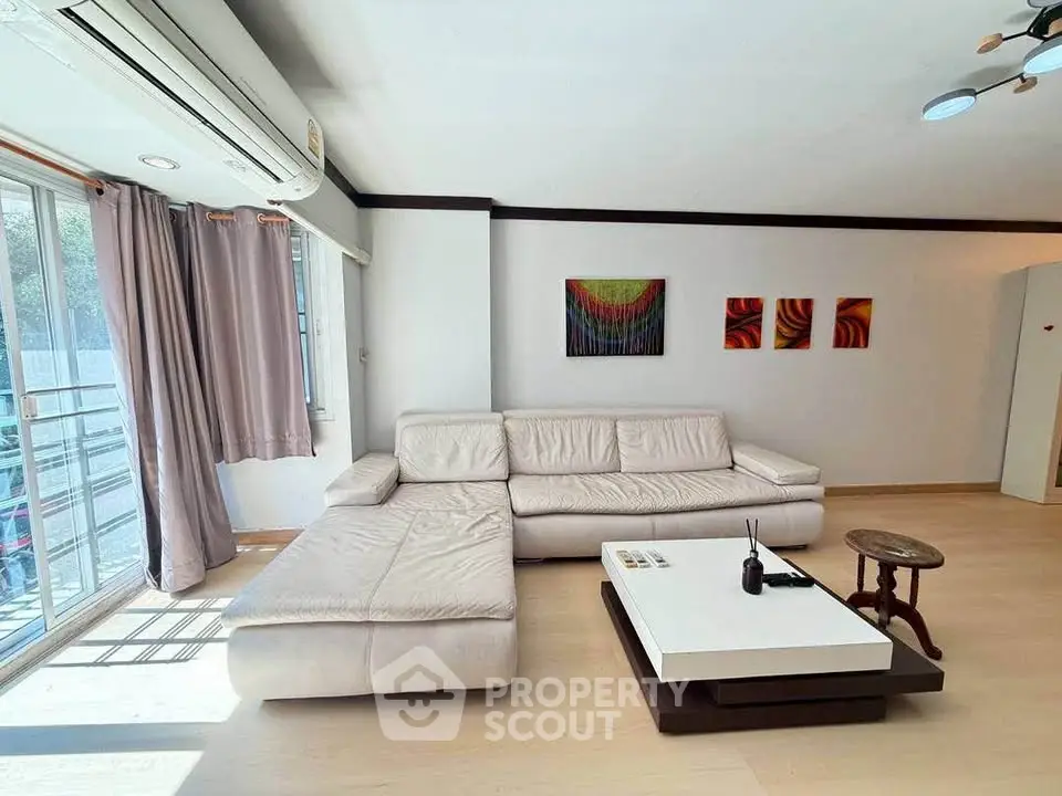 Spacious living room with modern white sectional sofa and stylish decor