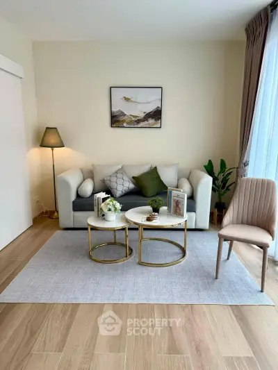 Chic living room with modern decor, cozy sofa, stylish coffee tables, and elegant lighting, perfect for relaxation.