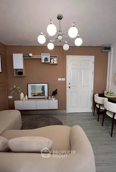 Stylish living room with modern decor and elegant lighting, perfect for cozy gatherings.