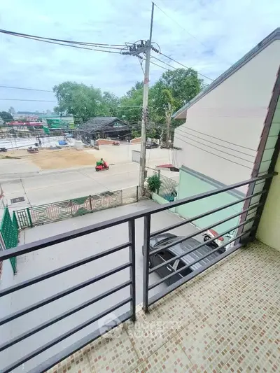 Charming balcony view overlooking a quiet street, perfect for relaxation and enjoying the outdoors.