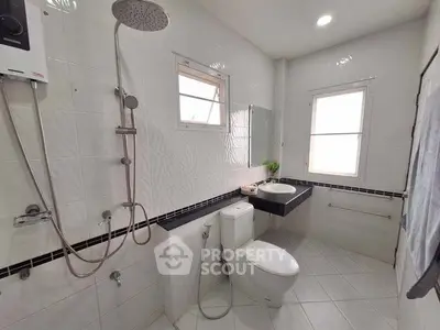 Modern bathroom with sleek fixtures and large window for natural light.