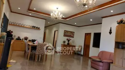 Spacious living room with elegant chandeliers and modern decor