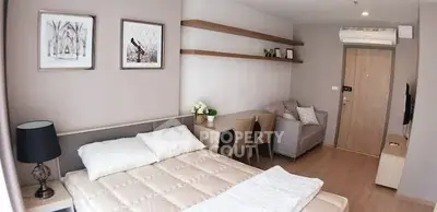 Modern studio apartment with cozy bed, stylish decor, and efficient layout.