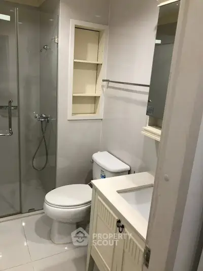 Modern bathroom with glass shower and built-in shelving