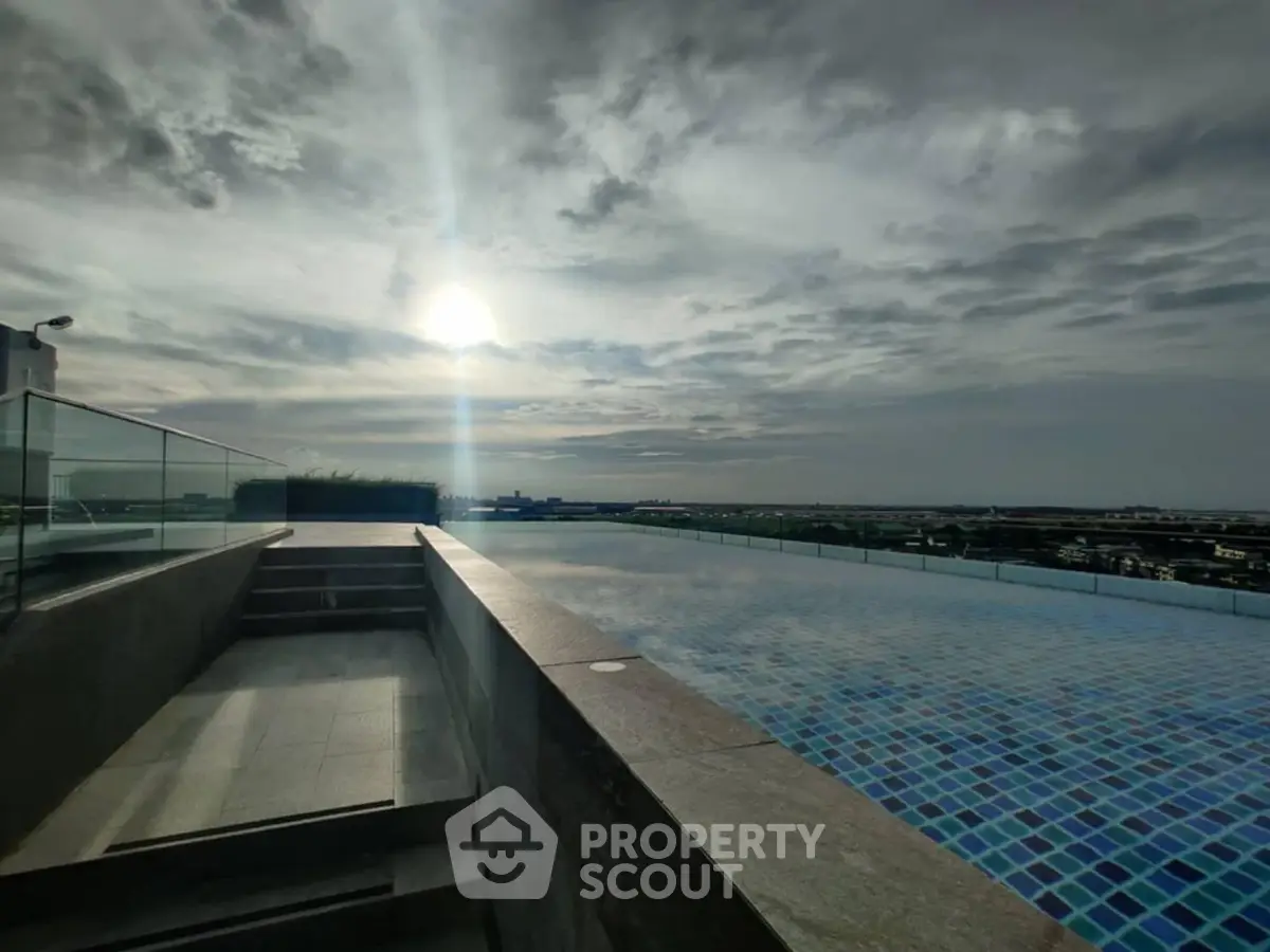 Stunning rooftop pool with panoramic city views at sunset