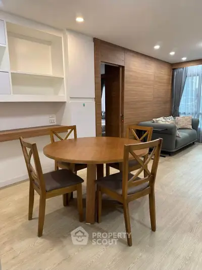 Spacious living room with wooden dining set and cozy seating area