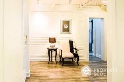 Elegant hallway with classic chair and side table in luxury home