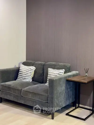 Cozy living room with plush gray sofa and stylish side table