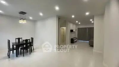 Spacious modern living room with elegant dining area and ambient lighting