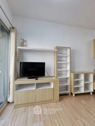 Modern living room with sleek wooden furniture and TV setup