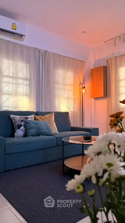 Cozy living room with stylish sofa, ambient lighting, and elegant decor for a welcoming atmosphere.