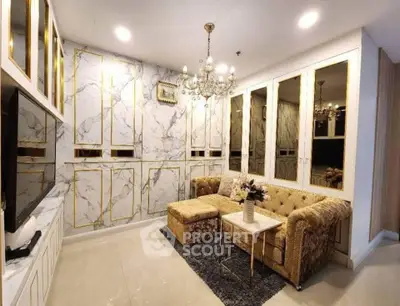 Luxurious living room with elegant marble walls and plush gold sofa, perfect for sophisticated living.