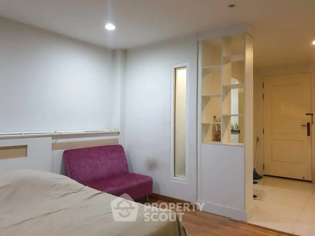 Cozy bedroom with modern design and stylish furniture in a well-lit apartment.