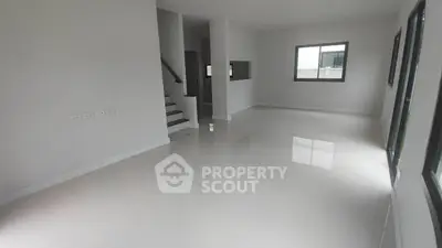 Spacious modern living room with glossy floors and large windows