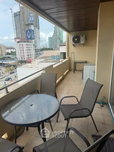 Spacious balcony with city view, perfect for outdoor relaxation and dining.