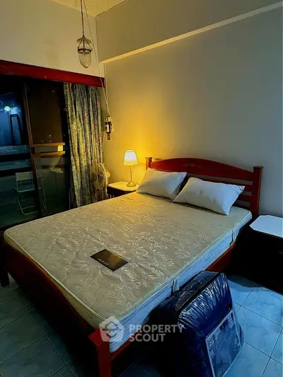 Cozy bedroom with ambient lighting and balcony access