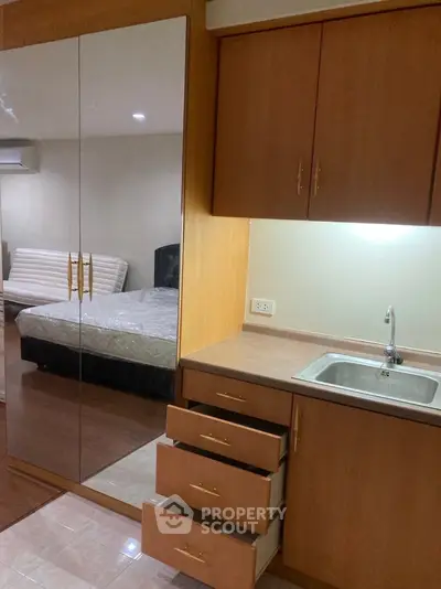 Cozy bedroom with built-in wardrobe and compact kitchenette