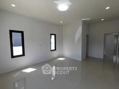 Spacious and bright empty room with modern windows and glossy tiled floor, perfect for customization.
