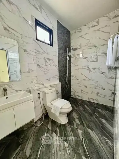 Modern bathroom with sleek marble tiles and contemporary fixtures