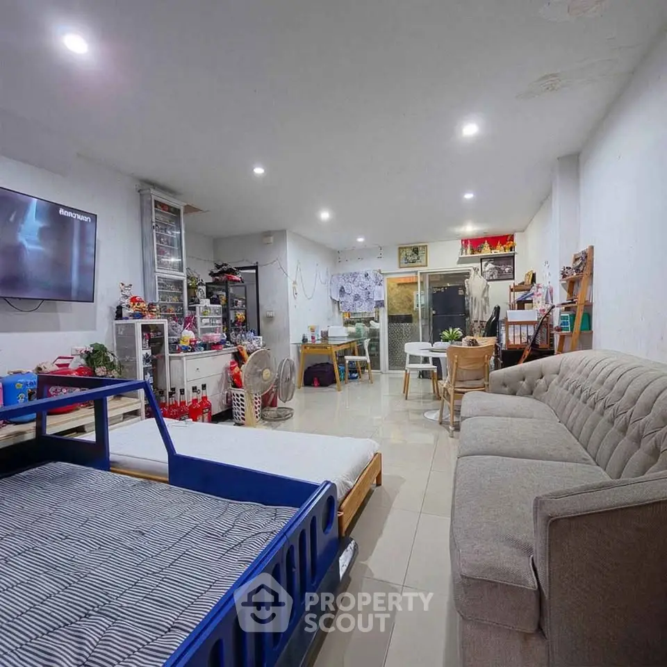 Spacious living room with modern decor and ample seating, perfect for family gatherings.