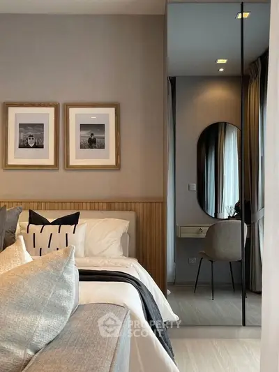 Elegant bedroom with modern decor and cozy ambiance, featuring stylish wall art and a chic vanity area.
