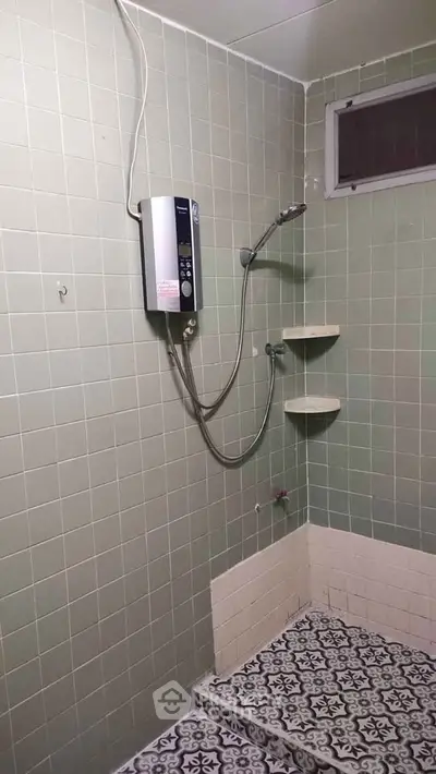 Simple bathroom with shower and patterned tile flooring