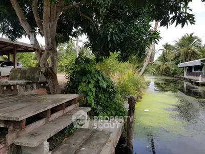 Charming riverside property with lush greenery and serene water views, perfect for nature lovers seeking tranquility.