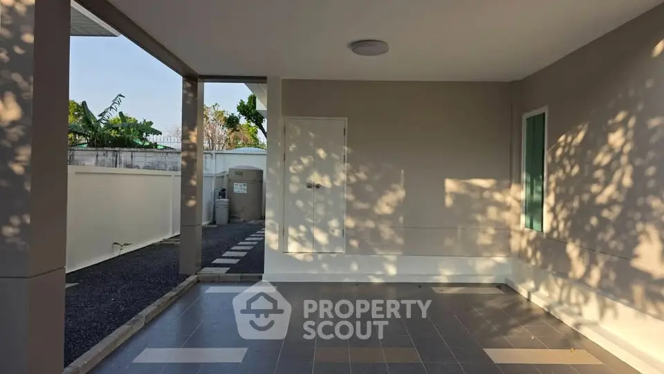 Spacious modern exterior with tiled flooring and natural light, perfect for versatile outdoor living.