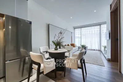 Modern open-plan living room with dining area and sleek kitchen appliances.