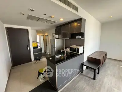 Modern open-layout kitchen with sleek cabinetry and appliances in a contemporary apartment.