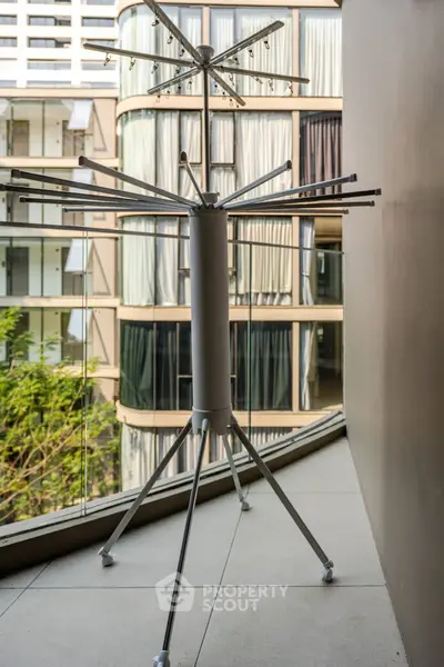 Modern balcony with sleek drying rack and city view, perfect for urban living.