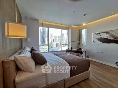 Luxurious bedroom with city view, modern decor, and ambient lighting in a high-rise apartment.