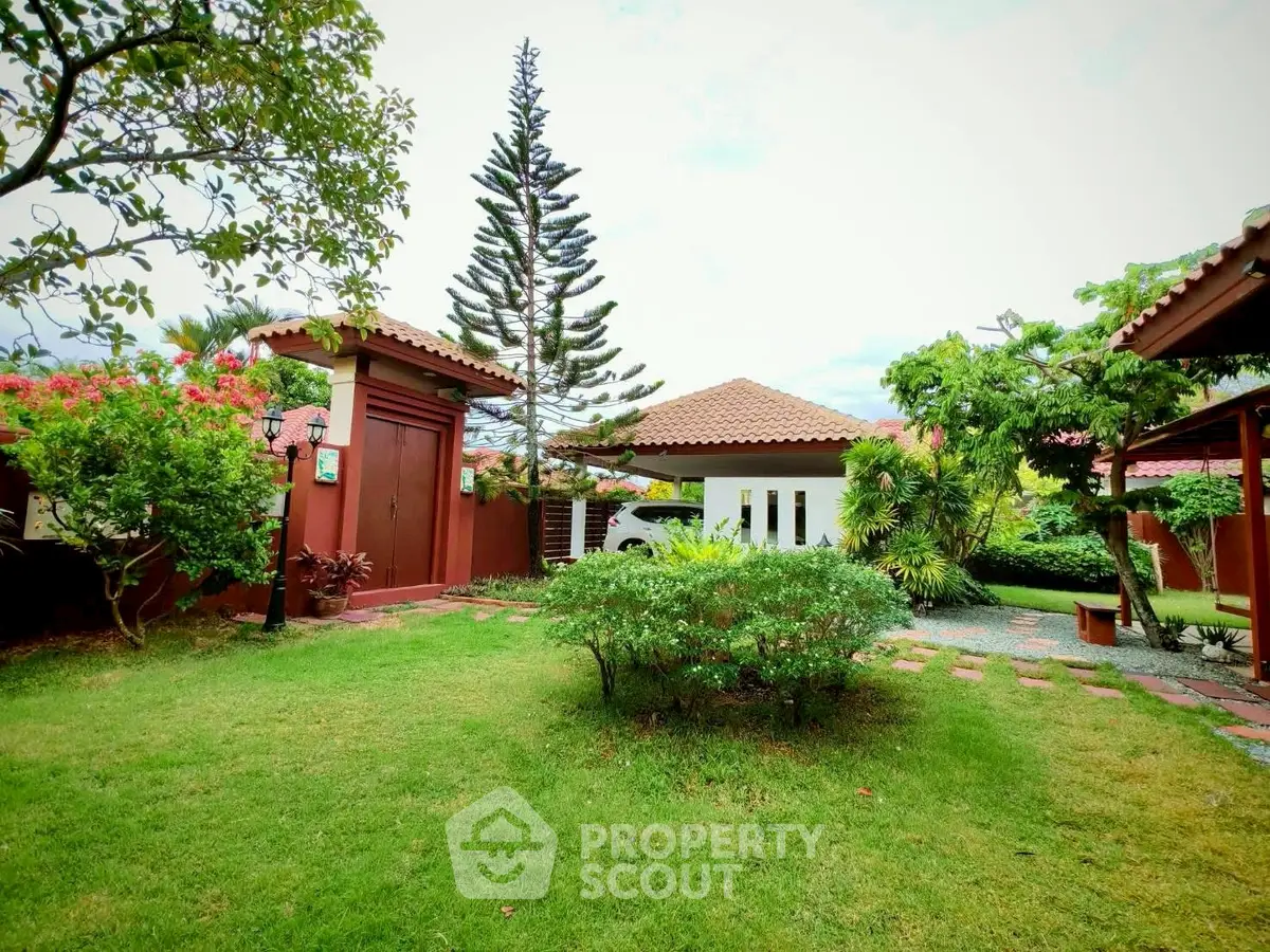 Charming garden view with lush greenery and quaint architecture, perfect for serene outdoor living.