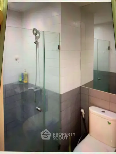 Modern bathroom with glass shower enclosure and sleek tile design
