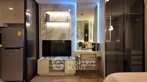 Modern living room with sleek design, featuring a TV, stylish shelving, and ambient lighting.