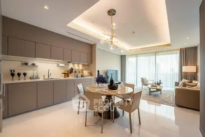 Luxurious open-plan kitchen and living room with modern decor and elegant lighting