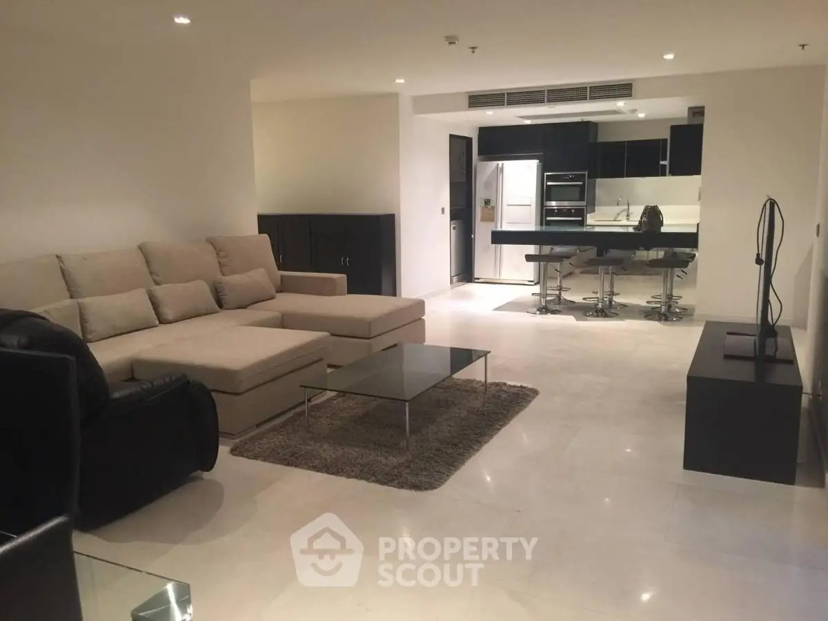 Spacious modern living room with open kitchen and stylish furniture