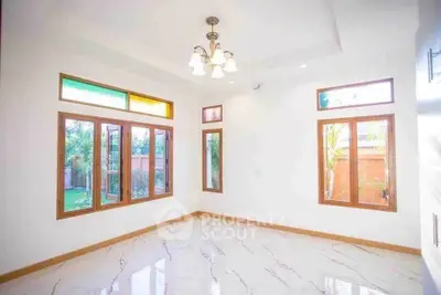 Bright empty room with large windows and marble flooring