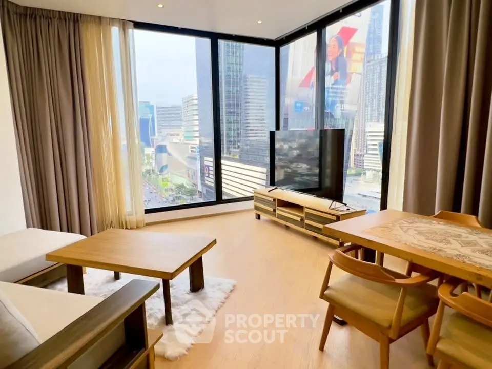 Modern living room with floor-to-ceiling windows offering stunning city views.